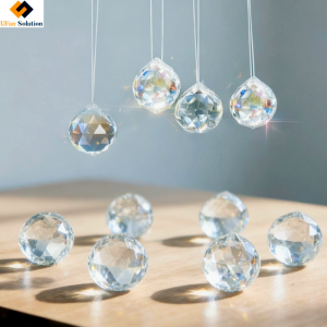 Close up view of a clear crystal sun catcher prism bead with a small hole for hanging