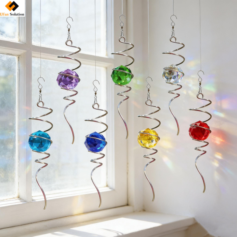 Wholesale Wind Spinner Spiral - Seven colorful crystal ball decorations with stainless steel spiral tails hanging by a bright window.