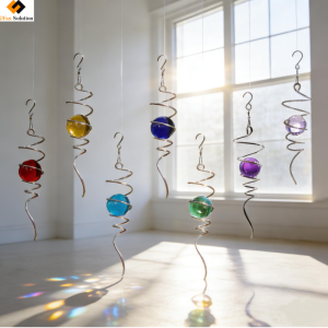 Six colorful Wind Spinner Stabilizer units with crystal balls and spiral tails hanging by a sunny window from UFan Solution.