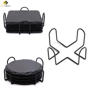 Black iron wire coaster holder holding four round coasters, showcasing its durable metal construction and 4-inch diameter compatibility.