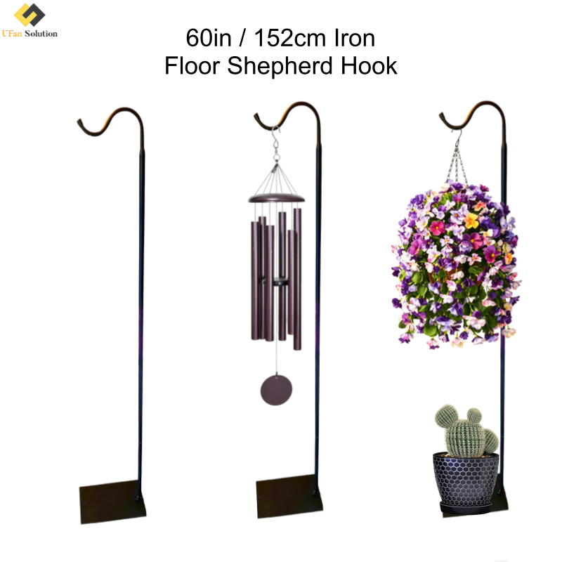 Three black shepherds hooks in a garden holding a wind chime, flowers, and having a plant onto the base of sheperd hook.