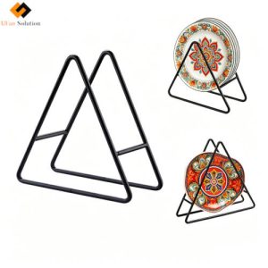 Black Iron Triangle Pot Trivet Stand displaying ceramic plates and coasters for kitchen organization