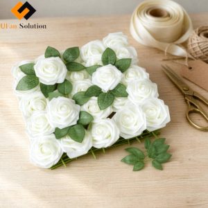 A close-up flat-lay of Artificial Flower Foam Rose with Stem for DIY with green leaves and full stems, arranged for DIY floral crafting. This image represents one item white artificial flower foam roses from a 40-bag set of artificial foam rose flowers for DIY, with no item mixed. Decorative accessories such as ribbon, twine, and scissors are shown for styling purposes only.