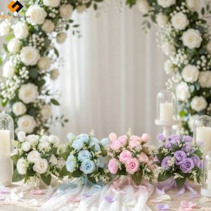 Four-color Artificial Silk Rose Bouquet Flowers Wholesale​ set featuring ivory, lake blue, pink, and lavender bridal bouquets with green fillers, displayed on a romantic event table setting.